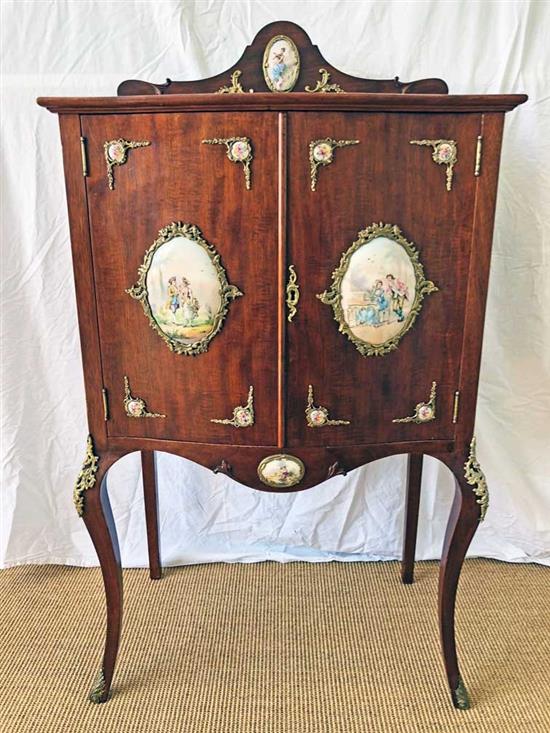 A mahogany cabinet with porcelain panels and brass filigree W.68cm